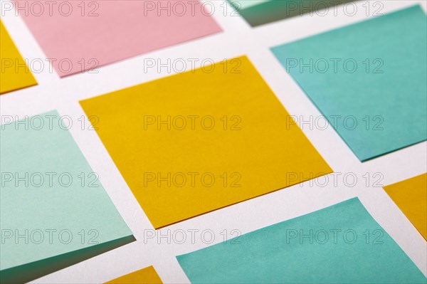 Close-up of colorful blank adhesive notes on white background
