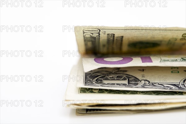 Close-up of folded dollar banknotes on white background