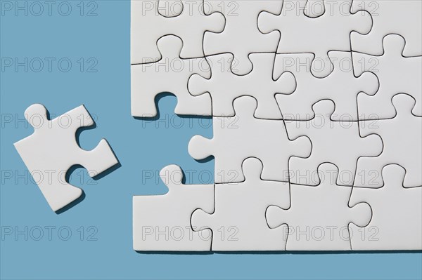 Jigsaw puzzle with missing piece on blue background