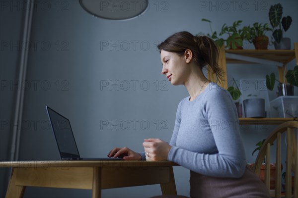 Woman using laptop at home