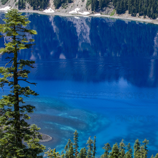 USA, Oregon, Cliffs reflected in calm surface of Crater lake
