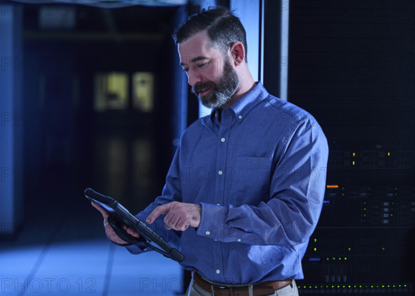 Man using tablet in data center