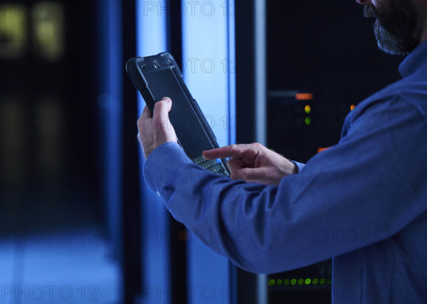 Close-up of man using tablet in data center