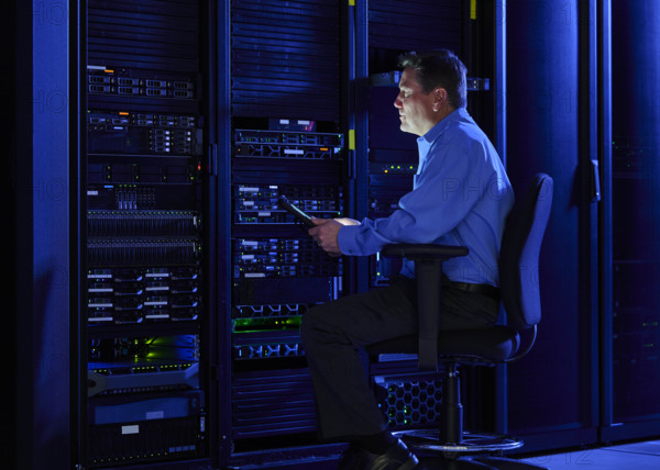 Man using digital tablet in data center