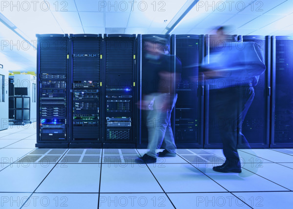 Two men walking in data center