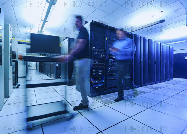 Two men walking in data center