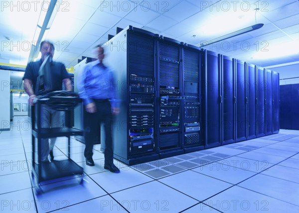 Two men walking in data center