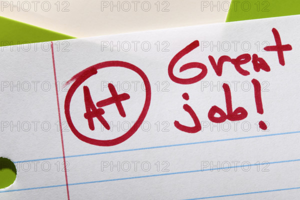 Close-up of A+ grade on lined paper