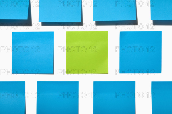 Blue and green post it notes on white background