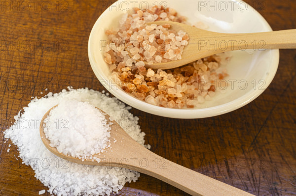 White and pink salt crystals on wooden spoons