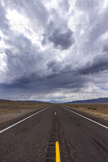 USA, Nevada, Henderson, Storm clouds over empty desert road