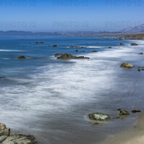 USA, California, San Simeon, Ocean waves washing sandy beach, long exposure