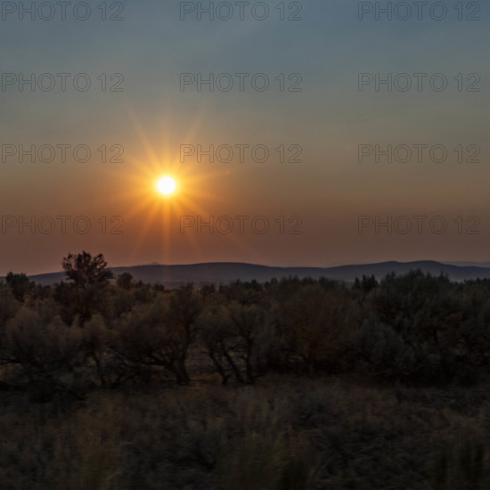 USA, Idaho, Twin Falls, Sun setting above desert landscape