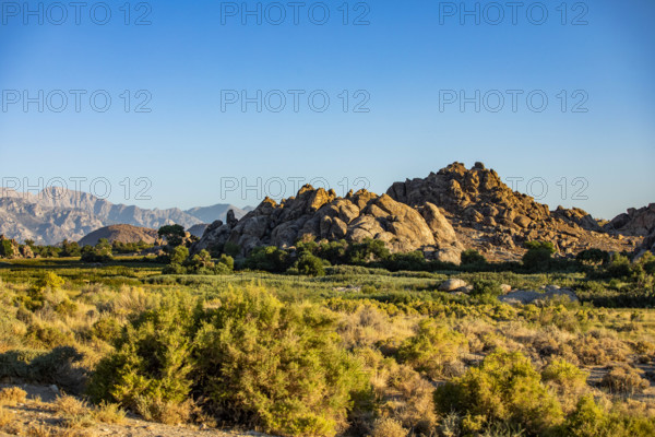 USA, California, Lone Pine, Rock formations and bushes on sunny day