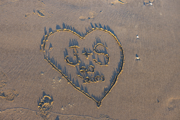 Heart with message in sand