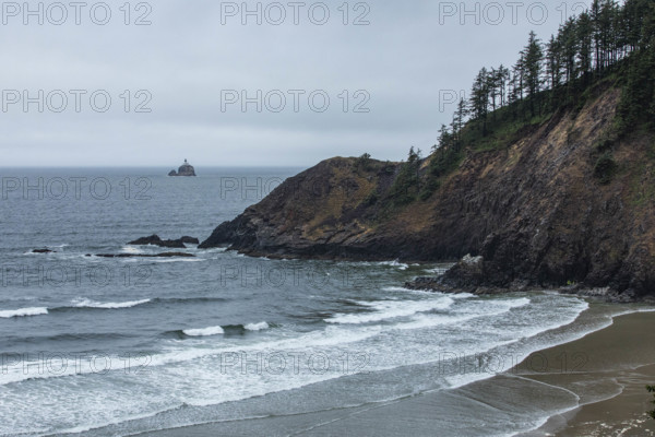 USA, Oregon, Sea waves washing beach and headland near Cannon Beach