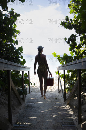 USA, United States Virgin Islands, St. John, Woman on path to tropical beach