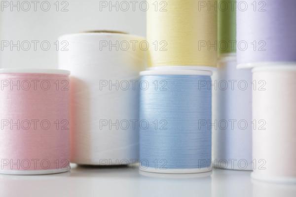 Studio shot of spools of pastel colored thread