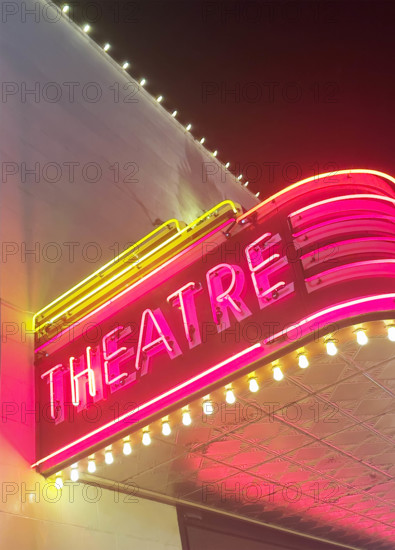 Illuminated theater marquee at night