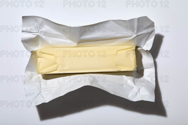 Overhead view of stick of butter on white background