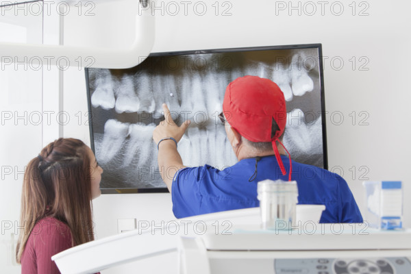 Dentist explaining X-ray to female patient