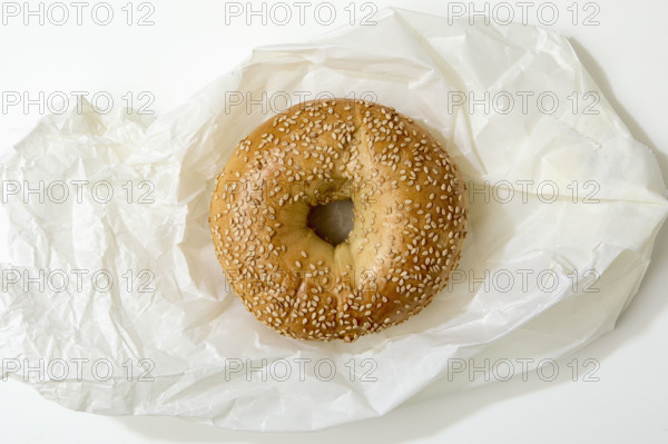 Overhead view of bagel on white background