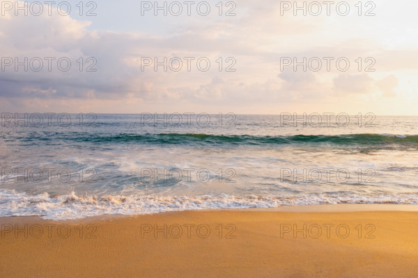 Mexico, Oaxaca State, Puerto Escondido, Costa Chica, Clouds over ocean waves on empty beach