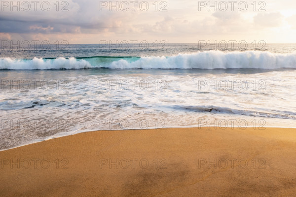 Mexico, Oaxaca State, Puerto Escondido, Costa Chica, Clouds over ocean waves on empty beach