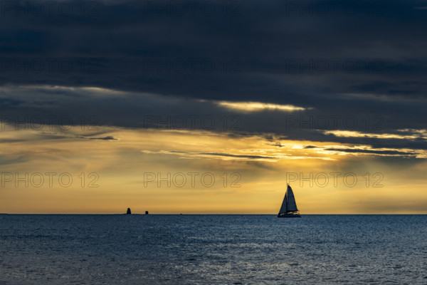 Costa Rica, Guanacaste, Playa Flamingo, Silhouette of sailboat on sea horizon at sunset