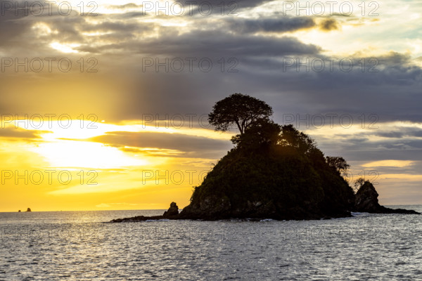 Costa Rica, Guanacaste, Playa Flamingo, Silhouette of small island at sunset