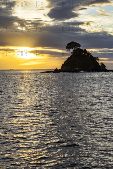 Costa Rica, Guanacaste, Playa Flamingo, Silhouette of small island at sunset