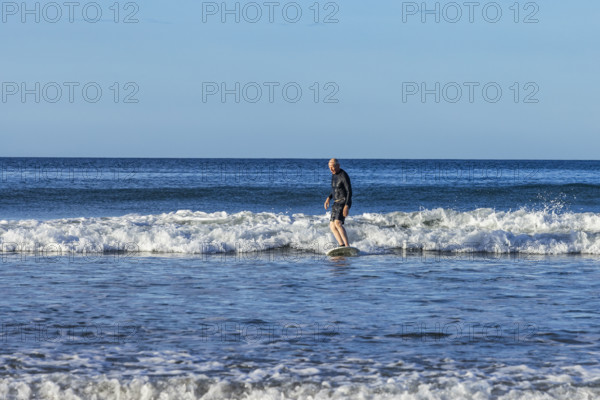 Costa Rica, Guanacaste, Playa Grande, Senior man surfing on sea wave