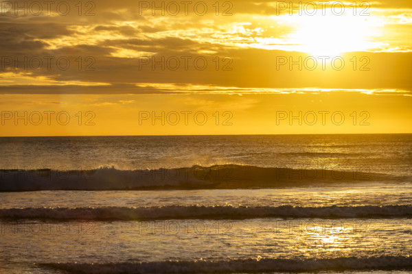 Costa Rica, Guanacaste, Playa Grande, Sun setting over calm sea
