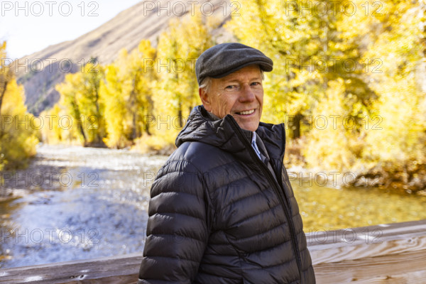 USA, Idaho, Bellevue, Portrait of senior blonde woman at river in autumn