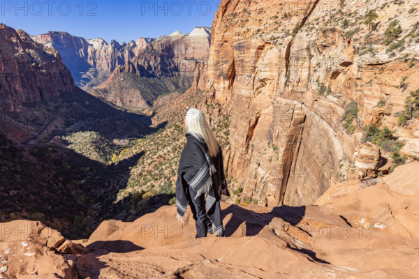 USA, Utah, Zion National Park, Rear view of woman in poncho at Zion Canyon Overlook