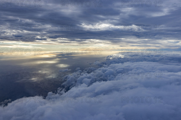 Clouds above Pacific Ocean from air at sunset