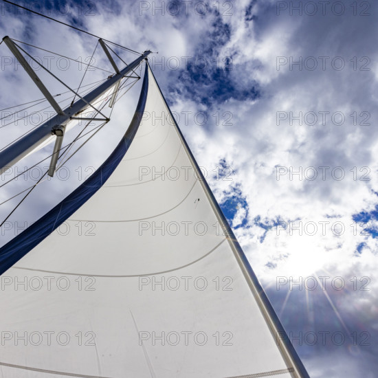 Low angle view of sails on catamaran against sky