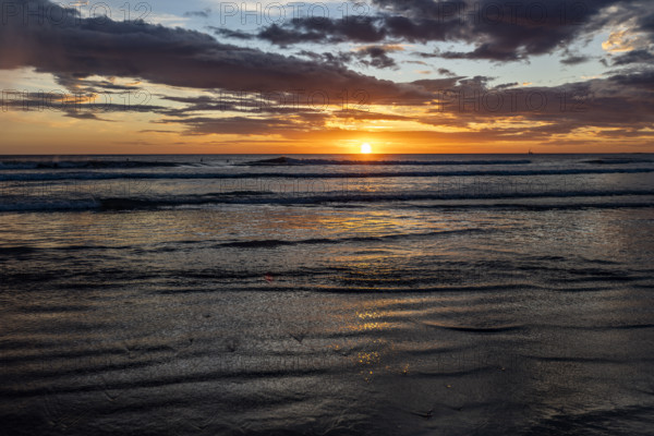 Costa Rica, Guanacaste, Playa Grande, Sunset over calm ocean on Playa Grande