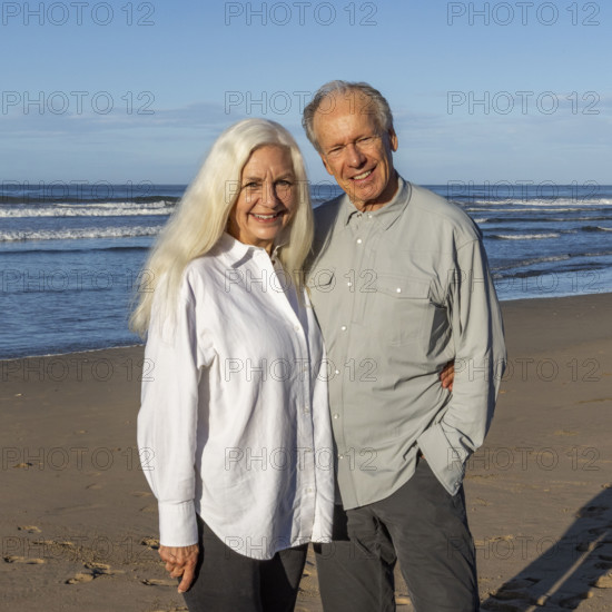 Costa Rica, Guanacaste, Playa Grande, Portrait of smiling senior couple on beach in morning