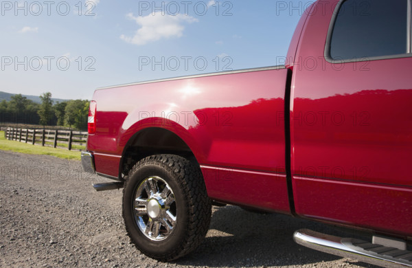 USA, New Jersey, Chester, Red pickup truck on dirt road on sunny day
