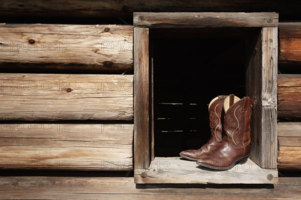 Cowboy boots in cabin window