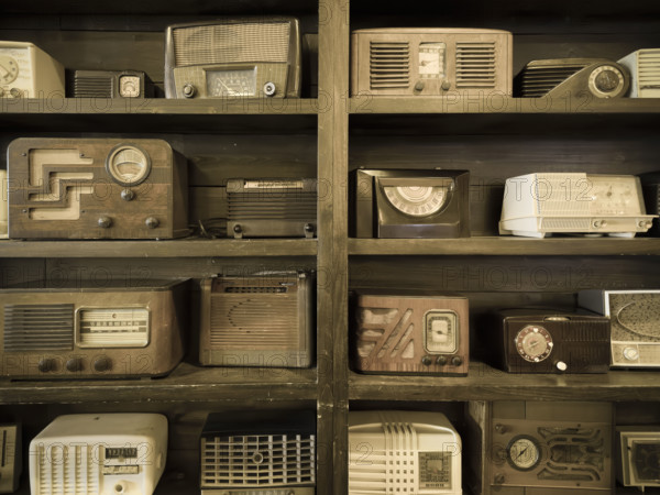 Antique radio collection on book shelf