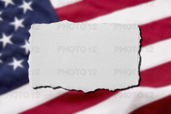 Torn paper with American flag background