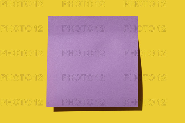 Blank purple post it note on yellow background