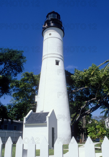 USA, Florida, Key West, White Key West lighthouse against blue sky on sunny day