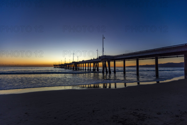 USA, California, Venice, Calm ocean and Venice Pier at sunset