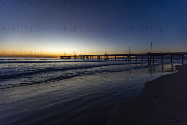 USA, California, Venice, Calm ocean and Venice Pier at sunset