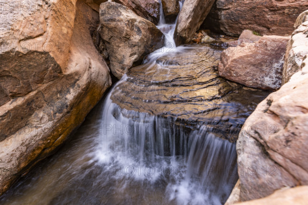 USA, Utah, Zion National Park, Creek flowing on eroded rocks, blurred motion