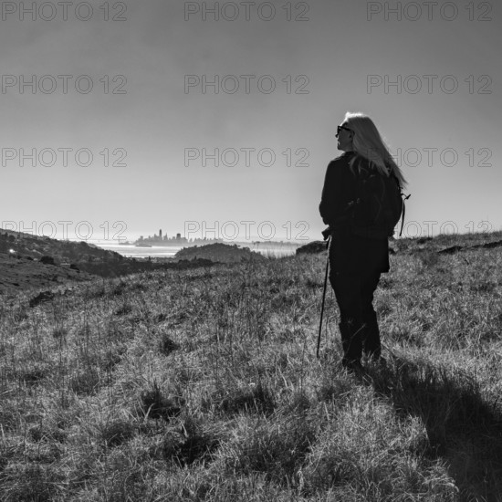 USA, California, Tiburon, Senior female hiker on Ring Mountain, black and white