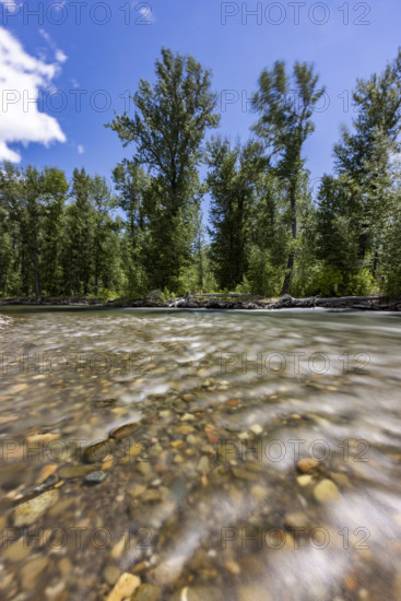 Surface view of motion blurred water in Big Wood River. Bellevue, Idaho, USA.